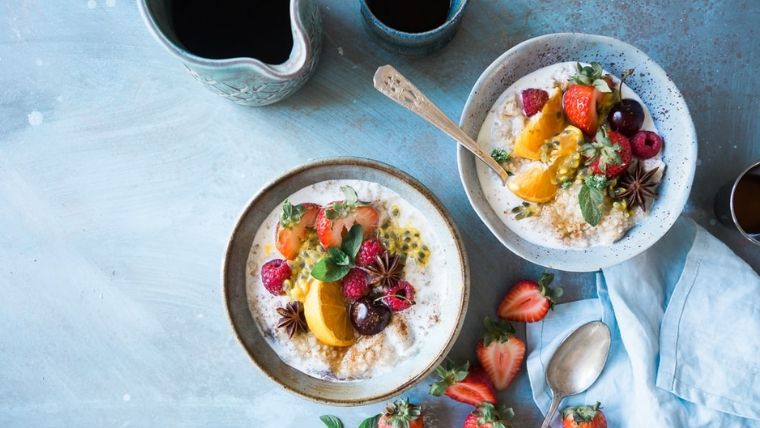 two bowls of oatmeal with fruits