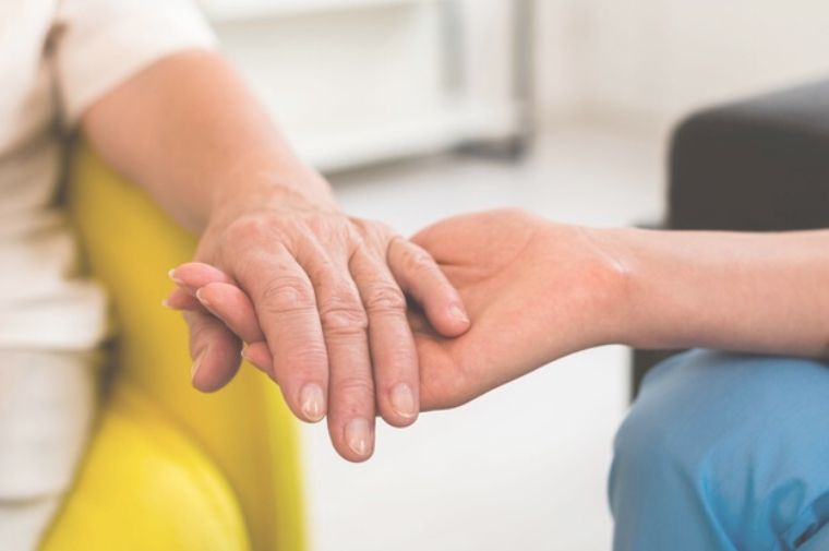 woman-holding-senior-woman-s-hand