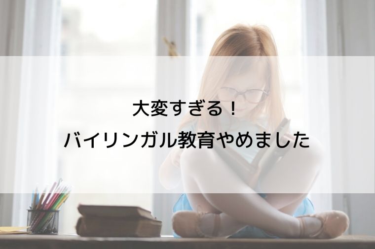 女の子があぐらをかいて本を読んでいる